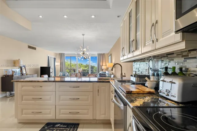 a kitchen with granite countertop a sink and cabinets