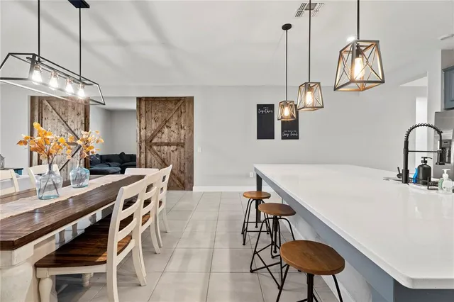 a living room with furniture a window and a chandelier