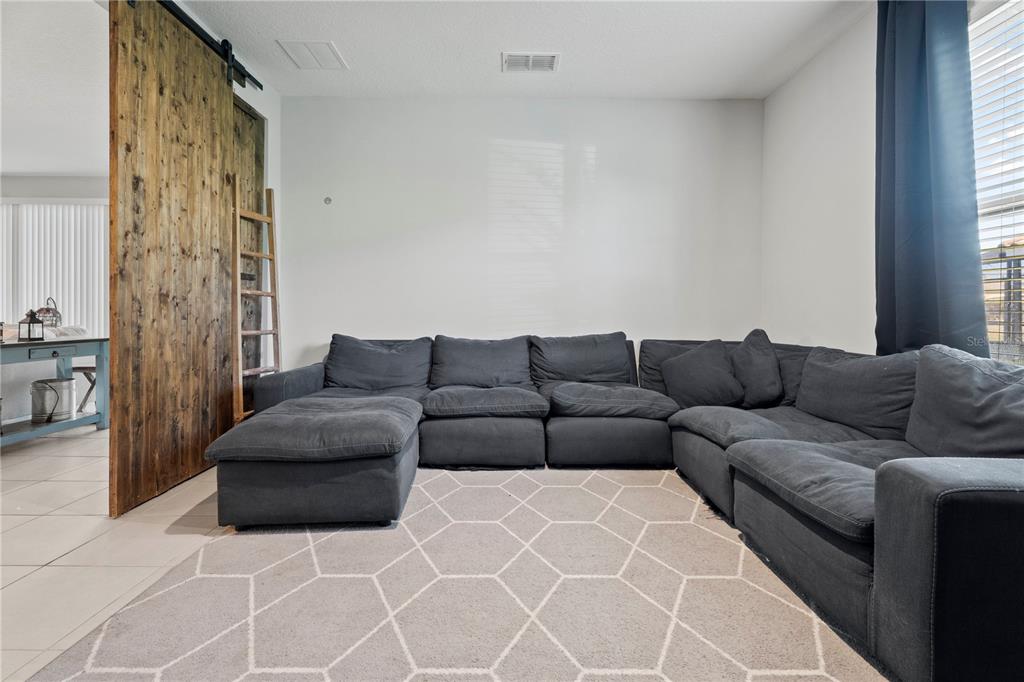 2731 Rialto Court Kissimmee, FL 34746 - Photo 19 of 49 a living room with furniture and a large window