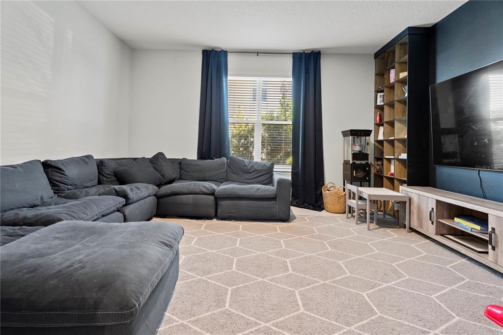 2731 Rialto Court Kissimmee, FL 34746 - Photo 21 of 49 a living room with furniture and a flat screen tv
