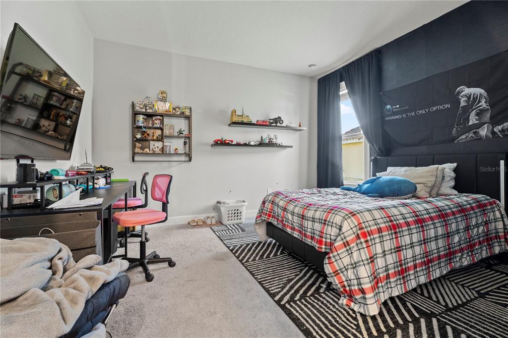 2731 Rialto Court Kissimmee, FL 34746 - Photo 22 of 49 a bedroom with a bed and a flat screen tv