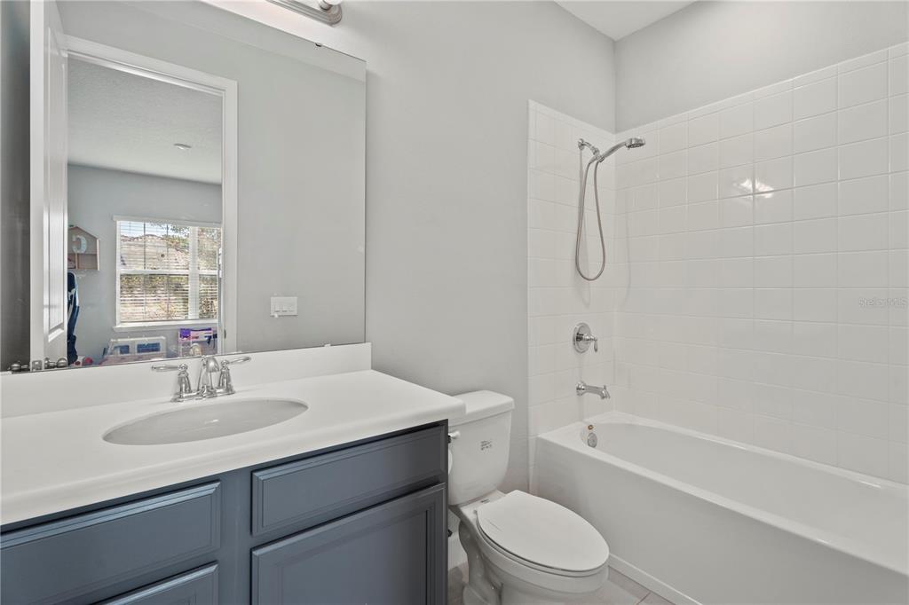 2731 Rialto Court Kissimmee, FL 34746 - Photo 25 of 49 a bathroom with a sink toilet vanity and shower