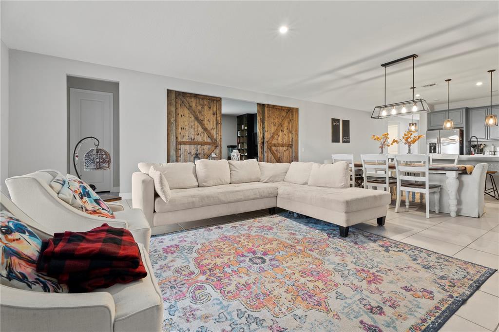 2731 Rialto Court Kissimmee, FL 34746 - Photo 29 of 49 a living room with furniture and a chandelier