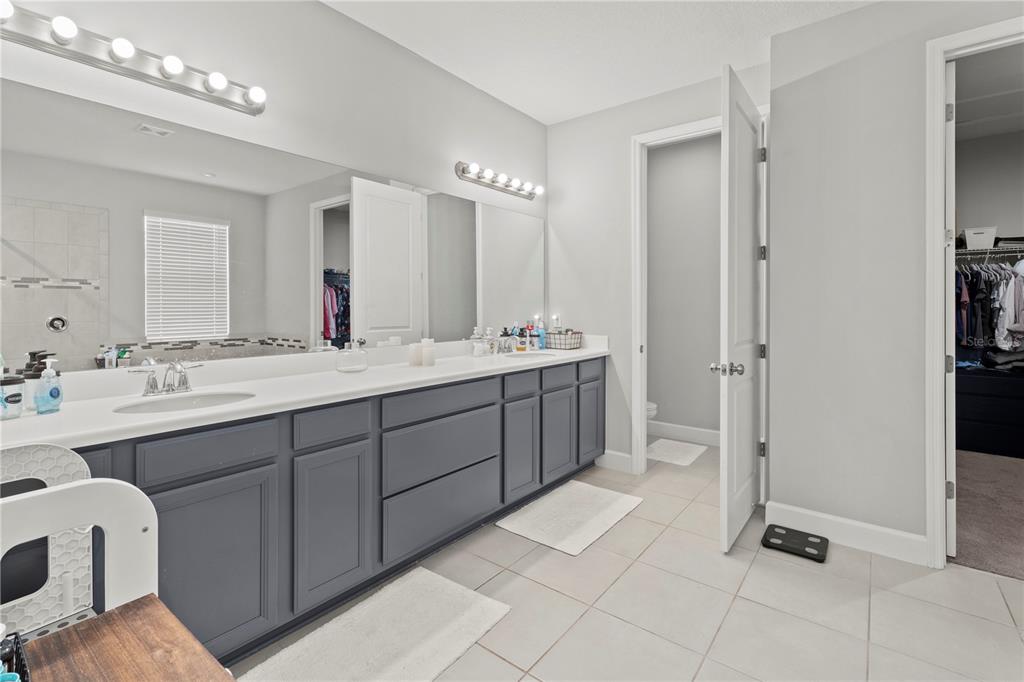 2731 Rialto Court Kissimmee, FL 34746 - Photo 32 of 49 a spacious bathroom with a double vanity sink a mirror and a bathtub