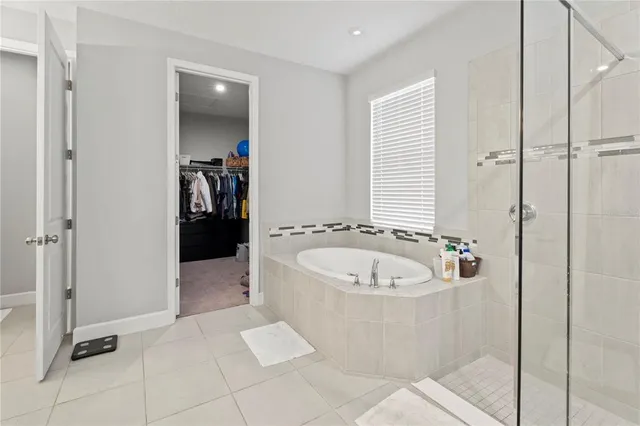 a bathroom with a tub and a shower