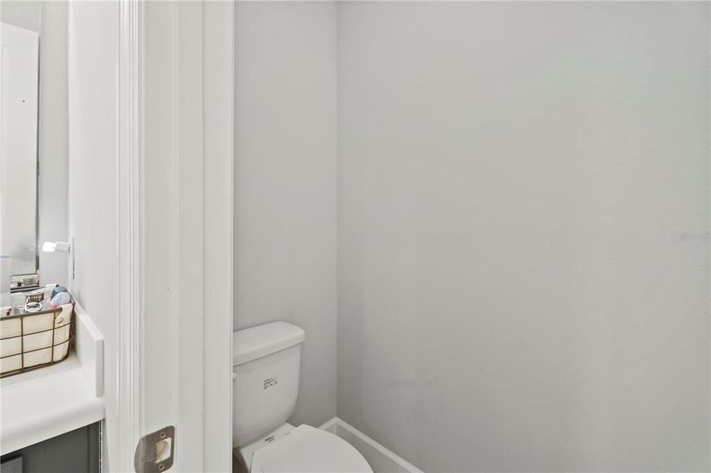 2731 Rialto Court Kissimmee, FL 34746 - Photo 35 of 49 a white toilet sitting next to a shower curtain