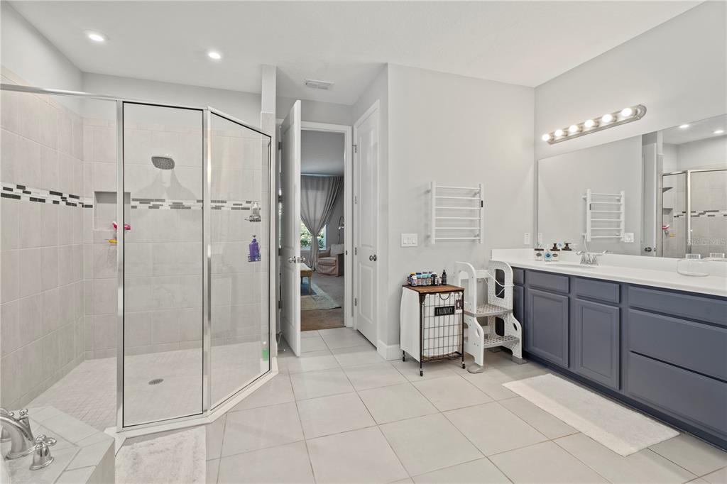 2731 Rialto Court Kissimmee, FL 34746 - Photo 36 of 49 a spacious bathroom with a mirror sink and shower