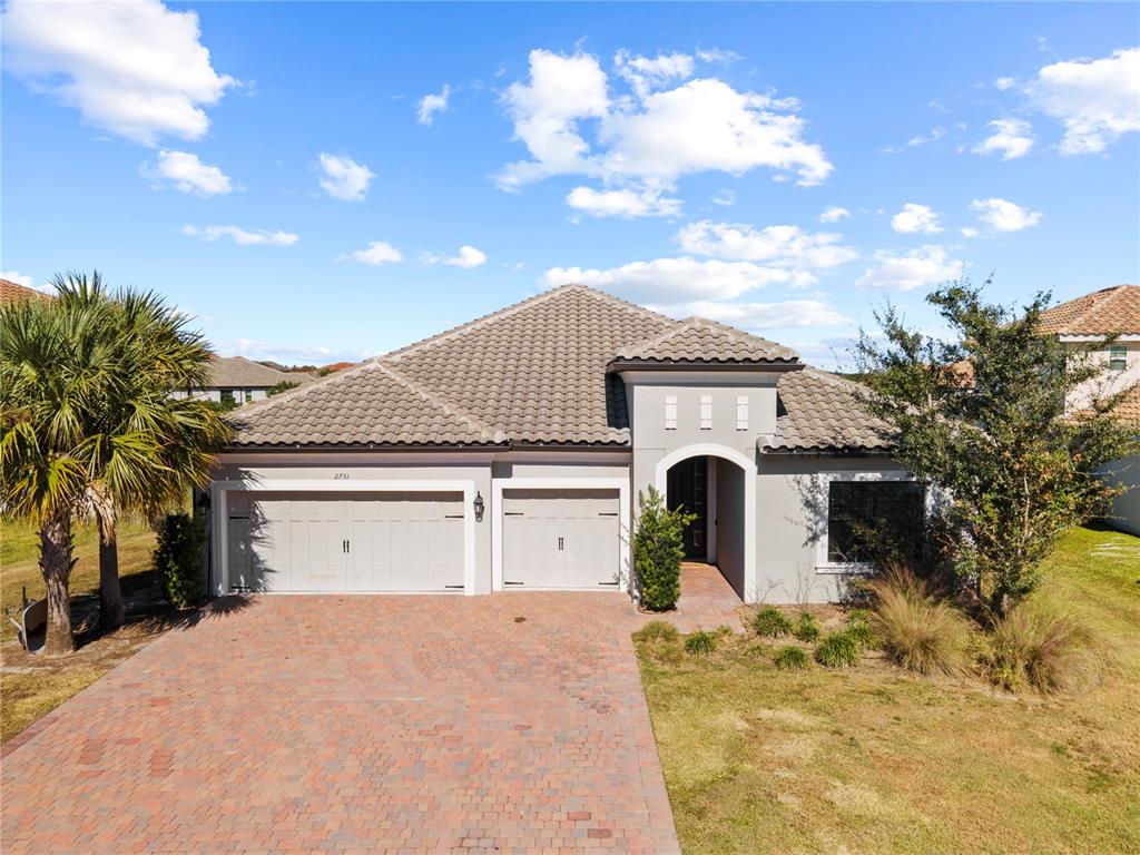2731 Rialto Court Kissimmee, FL 34746 - Photo 8 of 49 a front view of a house with a yard and garage