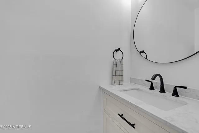 a bathroom with a sink and mirror