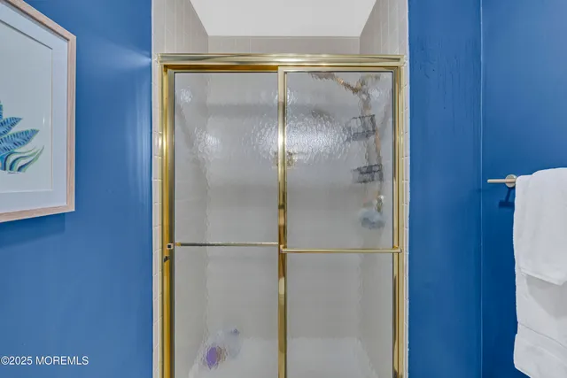 a bathroom with a glass shower door