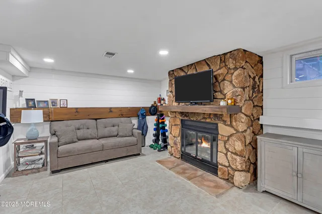 a view of a deck with furniture and a small yard