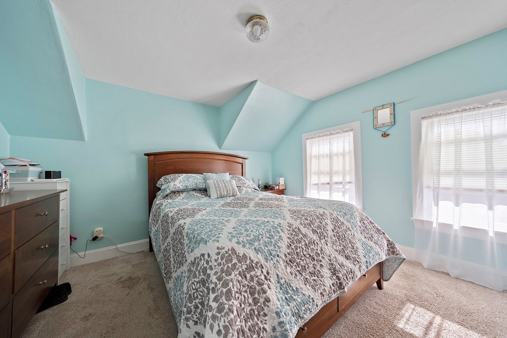 14 Vanness Road Weymouth, MA 02191 - Photo 17 of 27 a bed sitting in a bedroom next to a window