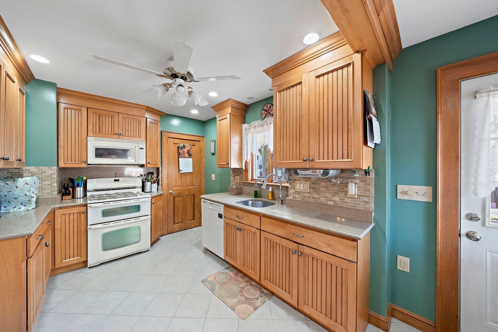 14 Vanness Road Weymouth, MA 02191 - Photo 8 of 27 a kitchen with stainless steel appliances granite countertop a sink and cabinets
