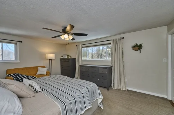 a bedroom with a large bed and a chandelier