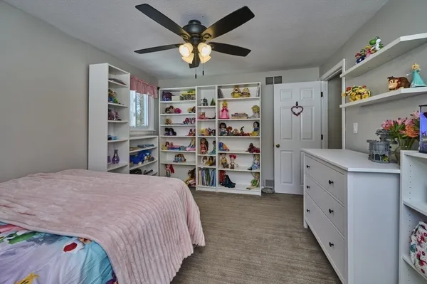 a spacious bedroom with a bed and a walk in closet