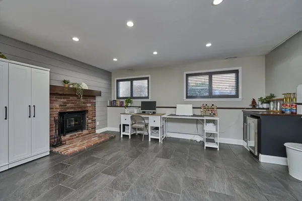 a living room with furniture a fireplace a dining table and a fireplace
