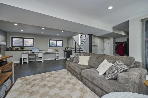 a living room with furniture and view of kitchen