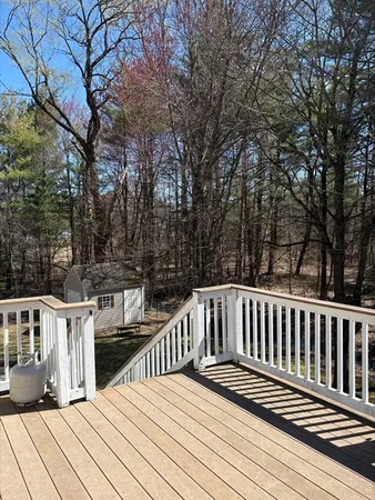 a view of deck with two chairs and wooden fence