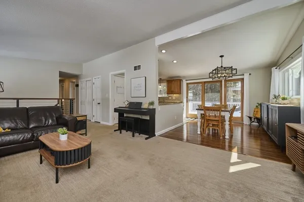 a living room with furniture and kitchen view