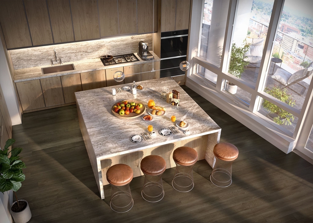 a kitchen with stainless steel appliances granite countertop a stove a sink and a microwave