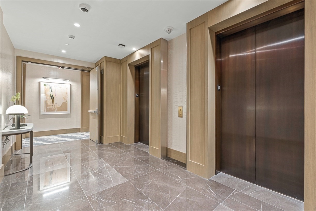 40 Trinity Place, Unit PH35A Boston, MA 02116 - Photo 3 of 22 a view of a hallway with wooden shelves