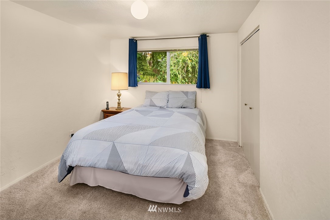 24022 7th Avenue West Bothell, WA 98021 - Photo 13 of 26 a bed sitting in a bedroom next to a window