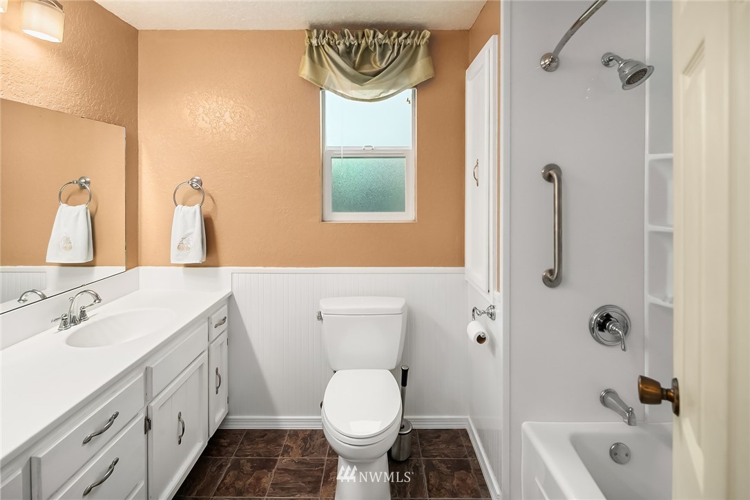 24022 7th Avenue West Bothell, WA 98021 - Photo 14 of 26 a bathroom with a granite countertop sink toilet and shower