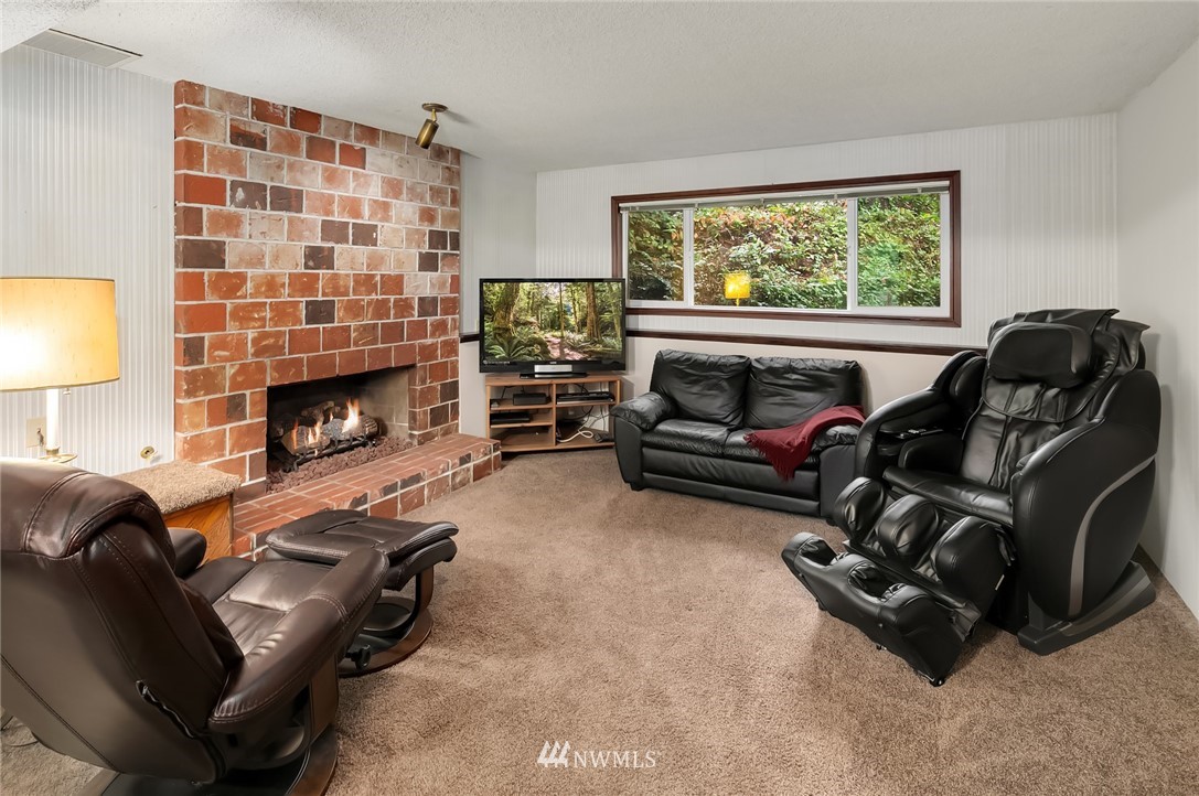 24022 7th Avenue West Bothell, WA 98021 - Photo 15 of 26 a living room with furniture window and a fireplace