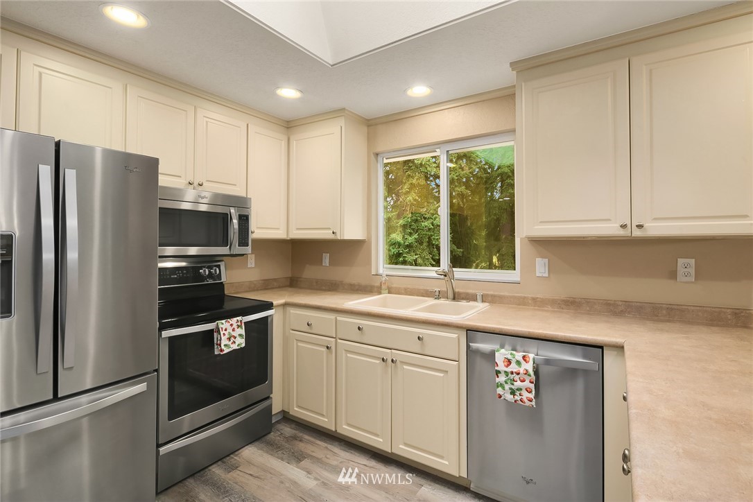 24022 7th Avenue West Bothell, WA 98021 - Photo 8 of 26 a kitchen with stainless steel appliances granite countertop a refrigerator sink and microwave