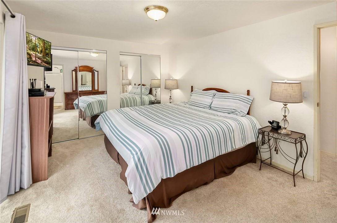 24022 7th Avenue West Bothell, WA 98021 - Photo 10 of 26 a bedroom with a bed and lamp