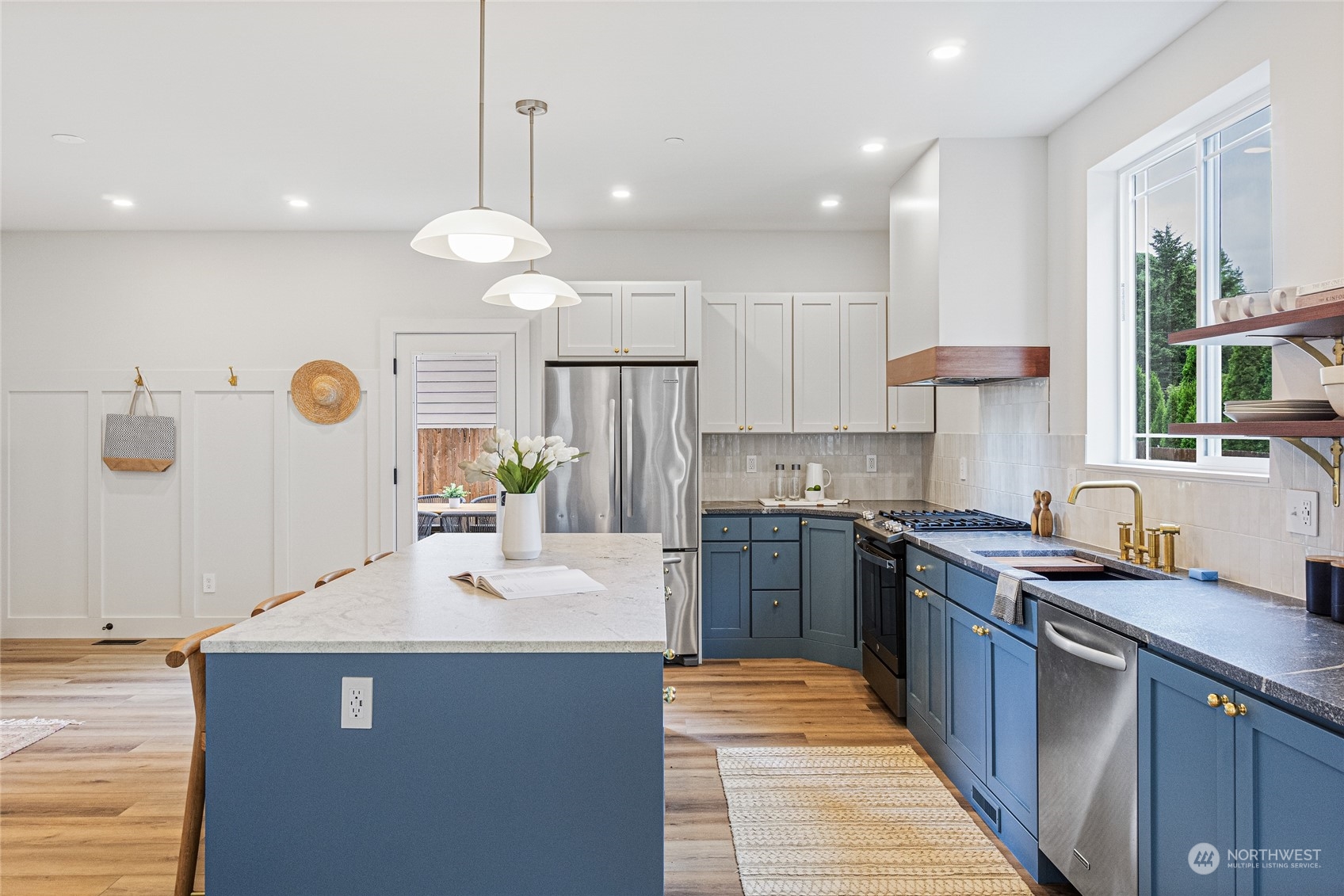 24310 13th Place West Bothell, WA 98021 - Photo 14 of 35 a kitchen with stainless steel appliances granite countertop a sink a stove and a refrigerator
