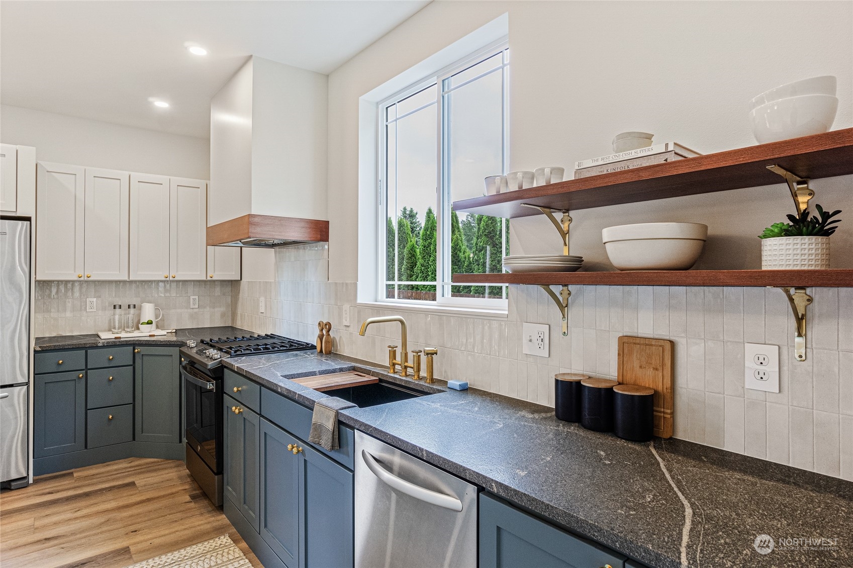 24310 13th Place West Bothell, WA 98021 - Photo 16 of 35 a kitchen with stainless steel appliances granite countertop a sink a stove and a wooden cabinets