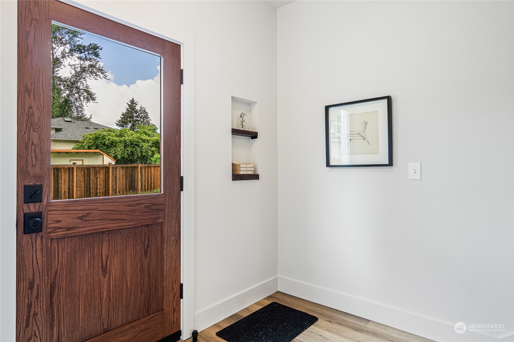 24310 13th Place West Bothell, WA 98021 - Photo 2 of 35 a view of a hallway with wooden floor and a bookshelf