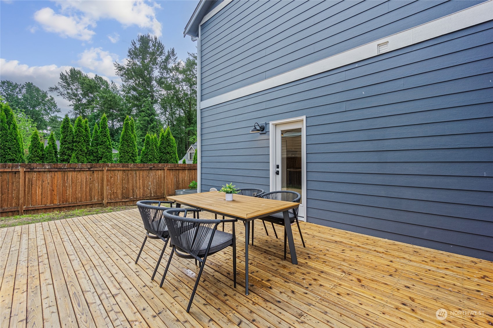 24310 13th Place West Bothell, WA 98021 - Photo 34 of 35 a patio with table and chairs and wooden floor
