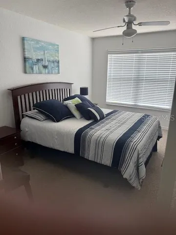 a bedroom with bed and a window