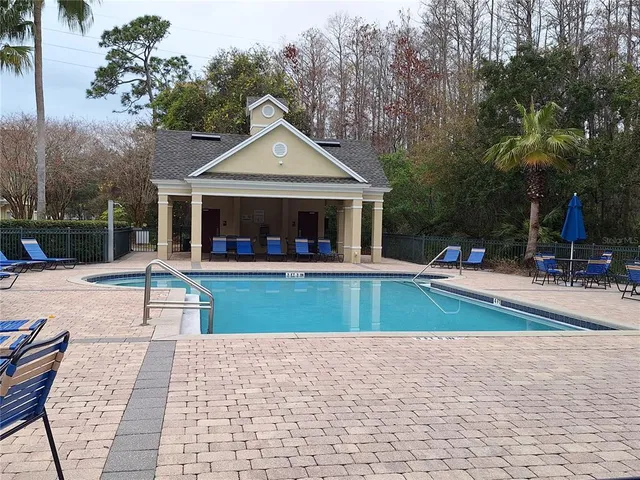 a view of a lake with a big yard and large trees