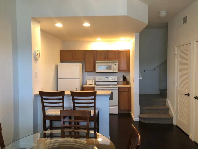a room with furniture a ceiling fan and a window