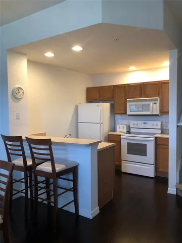 a kitchen with a wooden table and chairs