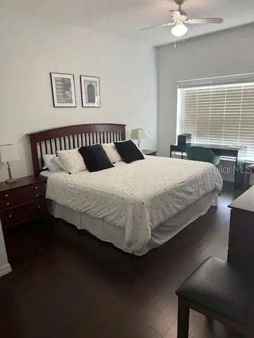 a bedroom with a large bed and a window