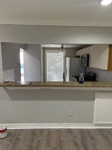 a kitchen with stainless steel appliances granite countertop a sink and a stove