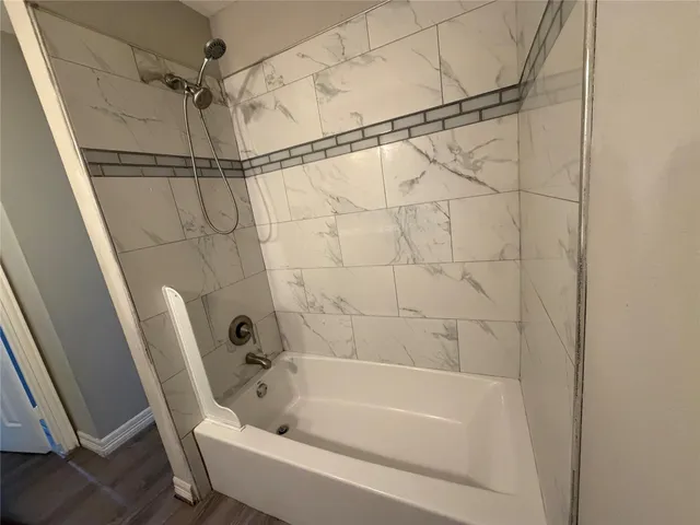 a bathroom with a bathtub and a shower
