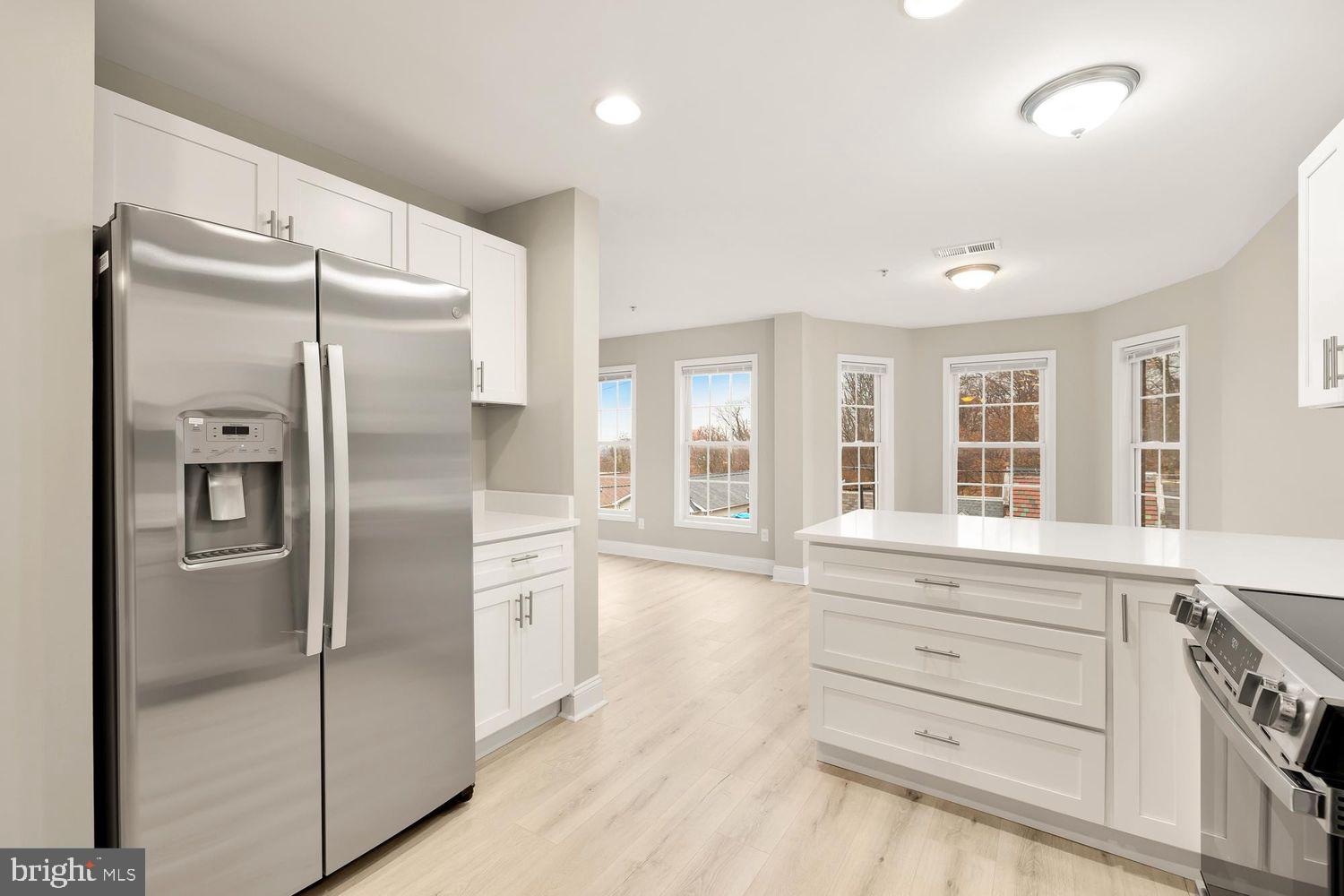 1753 W Street Southeast, Unit C Washington, DC 20020 - Photo 1 of 29 a kitchen with white cabinets and refrigerator