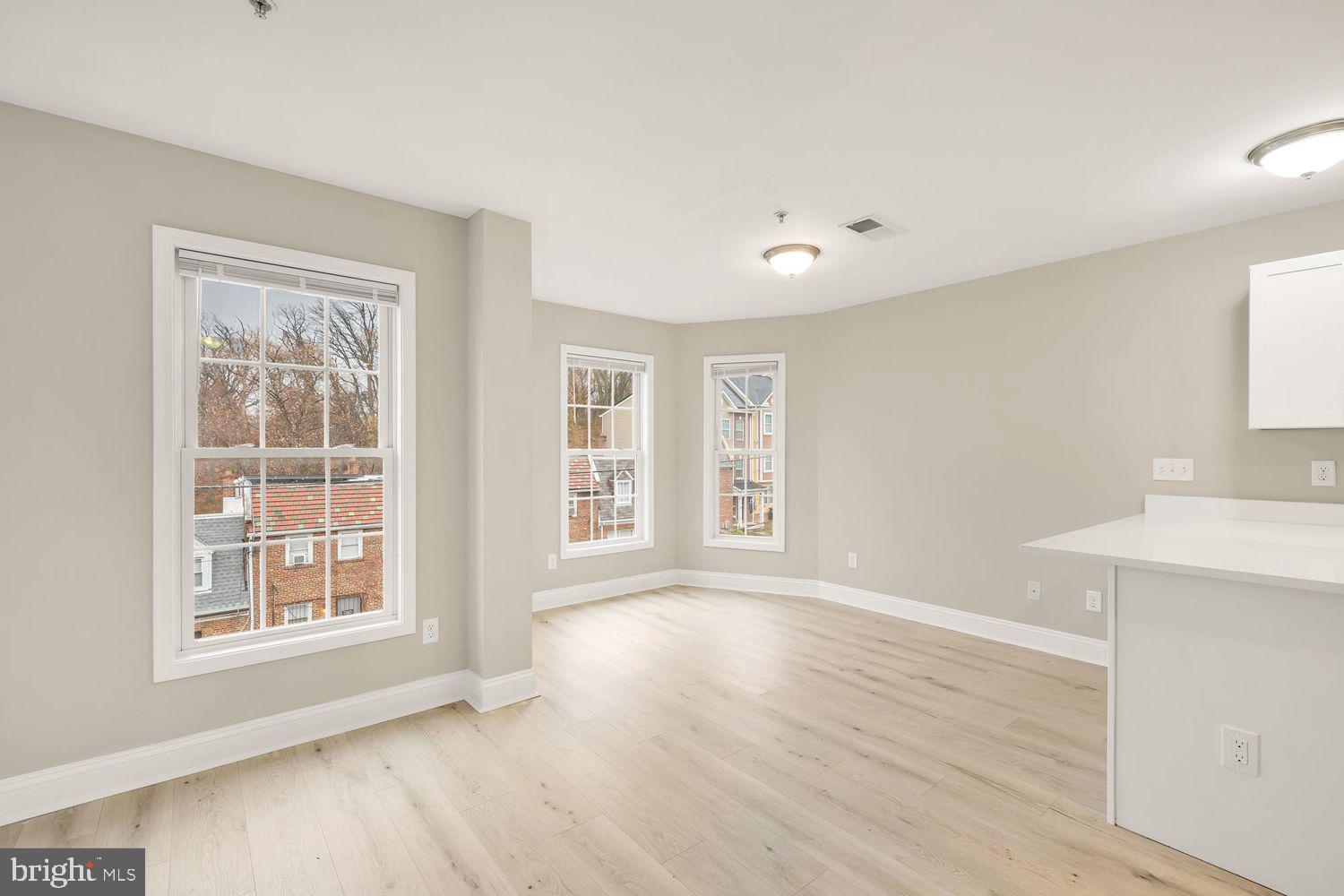 1753 W Street Southeast, Unit C Washington, DC 20020 - Photo 11 of 29 a view of an empty room with a window and wooden floor