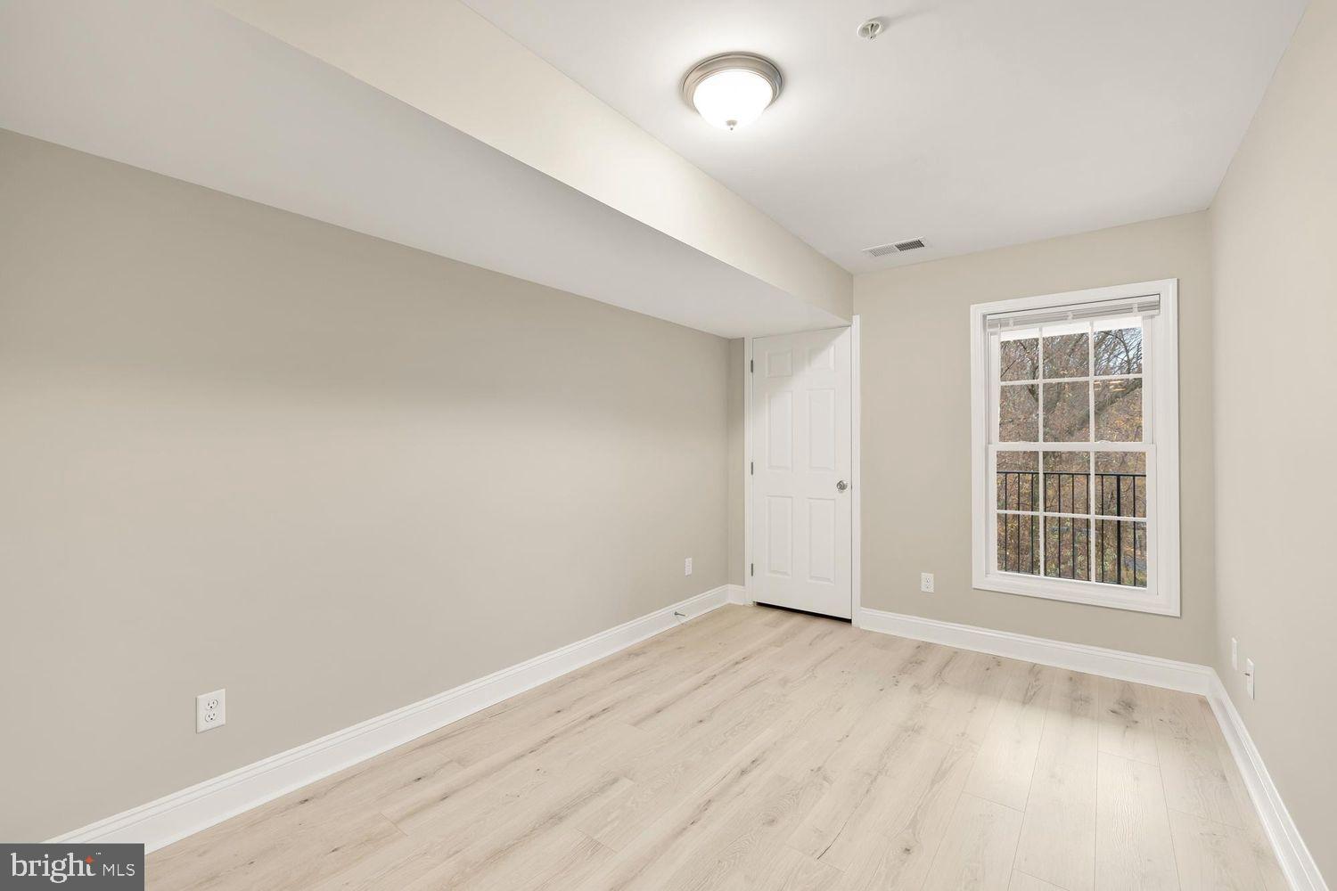 1753 W Street Southeast, Unit C Washington, DC 20020 - Photo 18 of 29 an empty room with windows