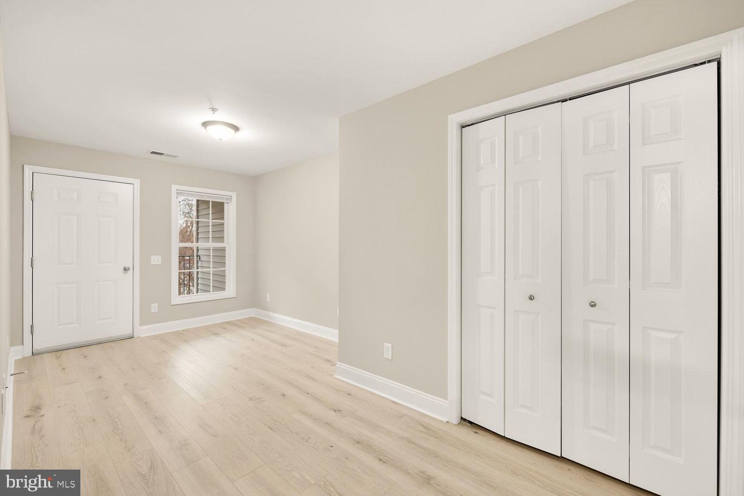 1753 W Street Southeast, Unit C Washington, DC 20020 - Photo 22 of 29 a view of an empty room with wooden floor and a window