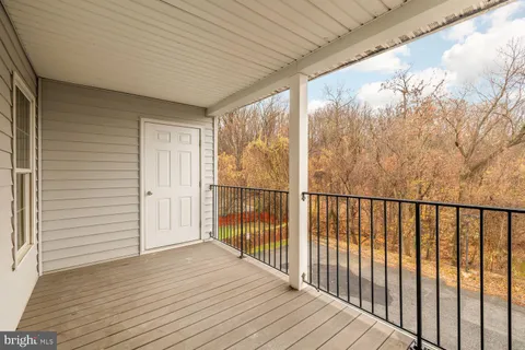 a view of a balcony with wooden floor
