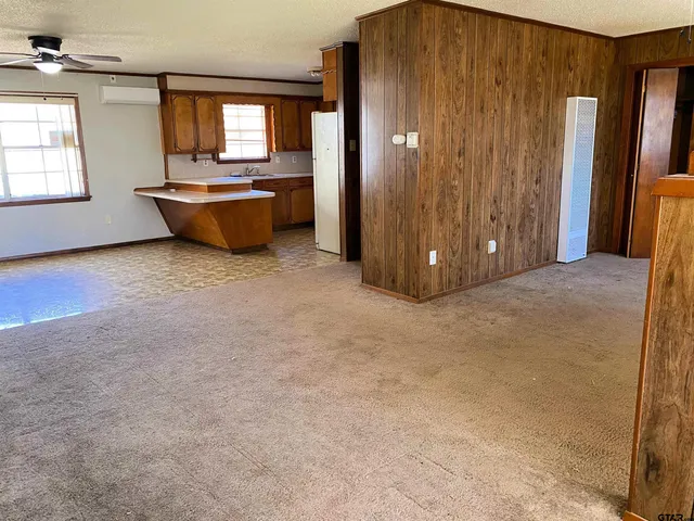 an empty room with fireplace and windows