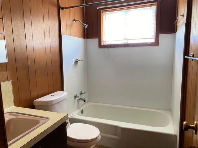 a bathroom with a toilet a sink and bathtub