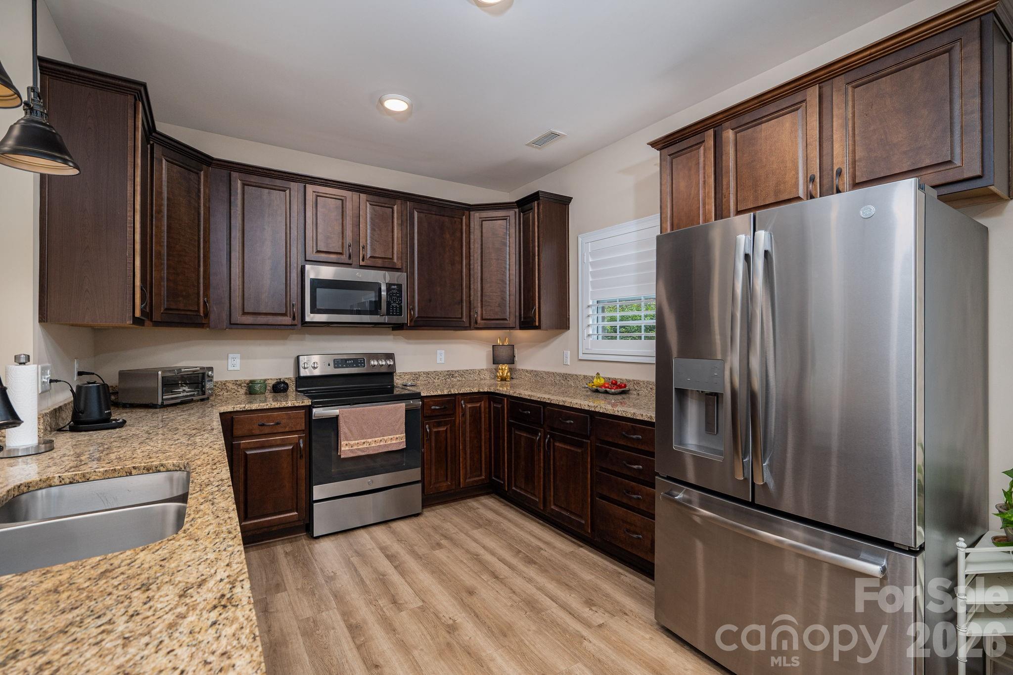201-t R T R Harris Drive Shelby, NC 28150 - Photo 13 of 25 a kitchen with granite countertop stainless steel appliances and wooden cabinets