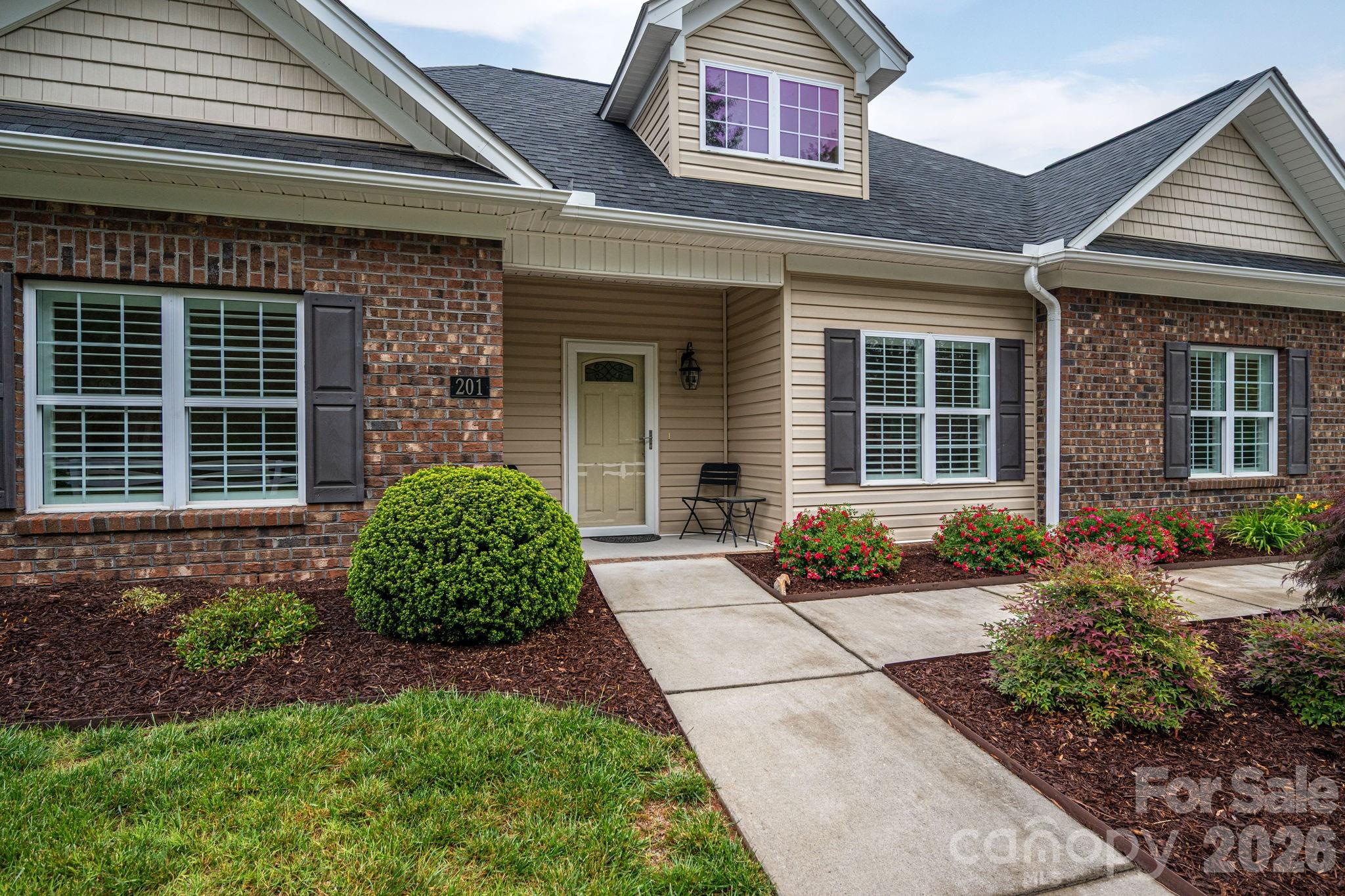 201-t R T R Harris Drive Shelby, NC 28150 - Photo 4 of 25 front view of a brick house with potted plants
